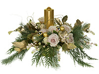 One trend for the Christmas season includes champagne glow like that of this floral design which mixes cedar, Quicksand and Vendela roses, snowberry, and gilded salal with candles and bling.