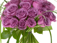 A lovely spiral hand-tied bouquet is created by mixing pink roses with lily grass for a beautiful effect.