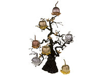 A delightful “pumpkin tree” displays miniature pumpkins painted in metallic colors with each one set in a hand-crafted nest of metallic wires. 