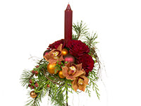 Candles are a popular and beautiful addition to Christmas arrangements like this one with copper colored orchids, red roses, banyan vine, evergreens, and holiday decorations.
