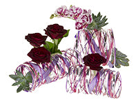 A new and innovative floral design for Valentine’s Day mixes pink orchids, red roses, and succulents with red and silver bling for a beautiful and unique holiday gift.