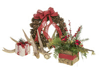 One trend for the Christmas season includes the cozy cabin Christmas: a woodland inspired floral design which mixes evergreens, mossy and berry branches, and holiday ornaments in a birch bark container with a pinecone wreath as well.