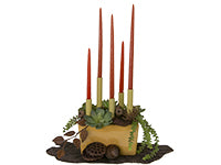 A beautiful parallel style arrangement of dried and permanent materials like succulents, lotus pods, eucalyptus pods, and pine cones also includes elevated tapered candles.