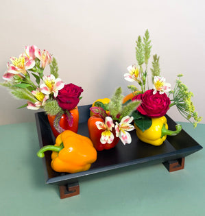 Cute wooden tray holding peppers, garden roses, dill, alstroemeria, clover and bunny tails.