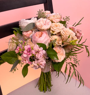 An elegant wedding bouquet full of Juliet and Charity garden roses, paired with Tanya spray roses, Peaches N' Dream spray roses, lisianthus, stock, grevillea, seeded eucalyptus and Israeli ruscus.