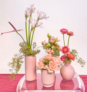 A collection of four mono-botanical arrangements, consisting of spray roses, ranunculus, lisianthus, Nerine lillies, and anthurium, paired with seeded eucalyptus all in shades of blush.