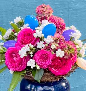 Filled with vibrant spring blooms from Florabundance.com and a playful touch of Easter eggs.
