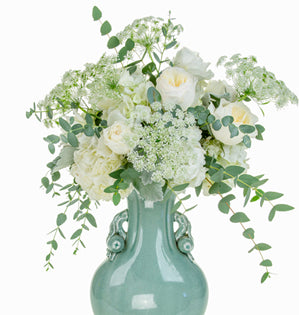 Hydrangea, airy Queen Anne’s lace, and lush garden roses in a green vase.
