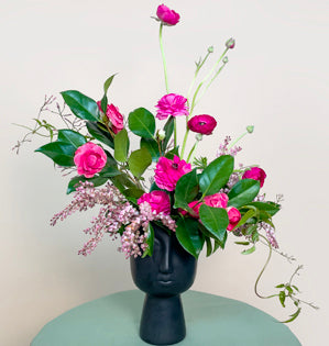 a stunning contemporary arrangement of blooming camellia and lush pink pieris.