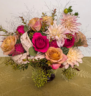 Roses and Dahlias in an arrangement.