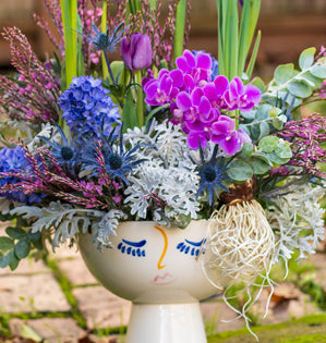 Face Vase with purple flowers.