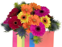 A bright and beautiful floral design mixes several multi-colored large and small Gerbera daisies in orange, pink, yellow and dark red for a lovely effect.