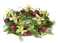 Orchids, red roses and evergreens mix beautifully in this non-traditional Christmas Centerpiece. It is accented with flat wire and Christmas balls holding Cymbidium orchid blossoms.