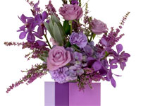 This gorgeous floral design in the Pantone Color of the Year 2014 Radiant Orchid features roses, orchids, liatris, carnations, hydrangeas, heather and leucadendron.