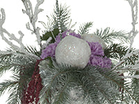 An arrangement of Douglas fir, flocked branches, light purple carnations, crystals, and a glittery snow ball.