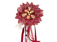 A spectacular composite bridal bouquet made of deconstructed cymbidium orchids in the Marsala color palette from which white, opaque red, and sheer red ribbons hang.