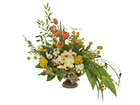 A sprawling arrangement of various berries, foliages, and flowers, including Phalaenopsis orchids, coral tulips, and yellow yarrow.