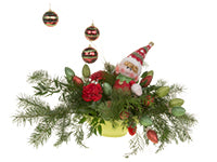 One trend for the Christmas season includes Christmas joy like that of this floral design which mixes evergreens and red carnations with fun and whimsical holiday ornaments.