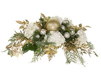 One trend for the Christmas season includes the Christmas in gold like that of this holiday floral centerpiece which mixes white hydrangeas, evergreens, gilded Italian ruscus, and gold and champagne holiday ornaments.