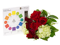 A complementary color harmony uses two colors on opposite sides of the color wheel like red and green, which are found in this bouquet that mixes two kinds of red roses with light green hydrangea. 