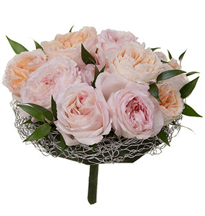 A bouquet of garden roses in soft peaches and pale pinks accompanied by Italian ruscus. 