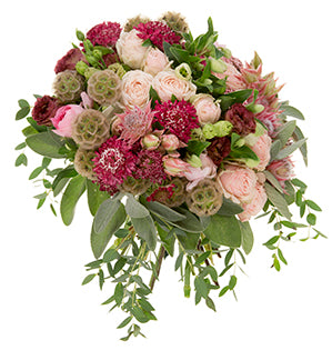 A textural bouquet of spray roses, chocolate brown lisianthus, Scabiosa pods, Parvifolia eucalyptus, the blushing bride protea, sage, ranunculus, wine-colored Scabiosa , rice flower, and hellebores.