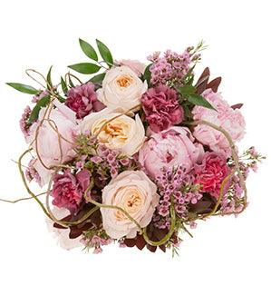 A beautiful bridal bouquet is created using a base of curly willow, then it mixes dark pink garden roses, light pink peonies, leucadendron, antique carnations, and wax flower.