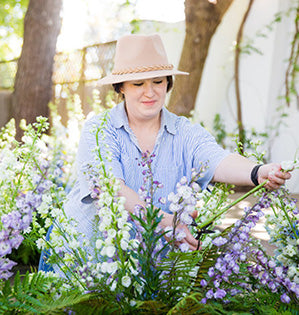 FDI graduate Meagan prunes snapdragons in her cutting garden.