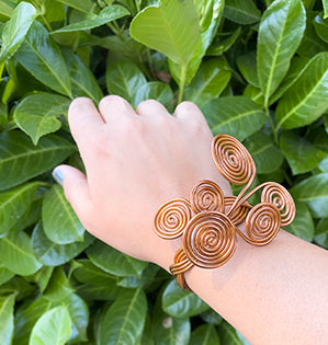 A spiraled contemporary wrist cuff made from copper aluminum wire.