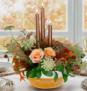 Fall Centerpiece filled with coppery tones, glowing battery tapers, and the soft beauty of peach roses, hydrangea, and Queen Anne’s lace.