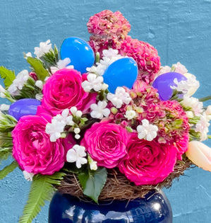 Filled with vibrant spring blooms from Florabundance.com and a playful touch of Easter eggs.