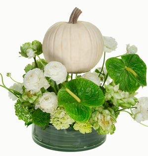 white pumpkin centerpiece surrounded by lovely green and white flowers.
