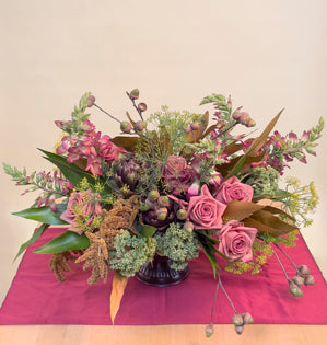 A foam free compote is filled with foxglove, dill, sedum, grevillea, amaranthus, and Barista roses.