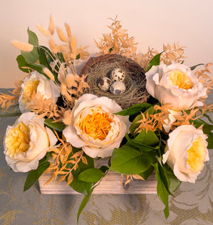 A fabulous nest design with a base of salal, Italian and israeli ruscus, dyed and preserved ruscus, and tinted bunny tail grasses. Paired with Effie garden roses, a woven nest, and 3 blown quail eggs.