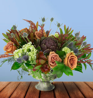 A design of muted elegance featuring roses, leucodendron, bromeliad, eryngium and more.