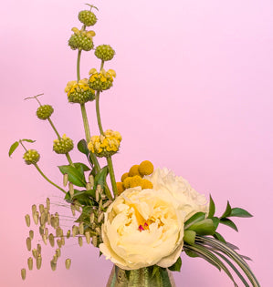 An abstract design using Jerusalem sage, craspedia, peonies, Italian ruscus, salal, fatsia, lily grass and sea oats.