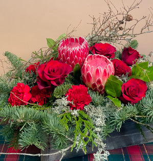 lichened cover branches with textured protea, and romantic roses