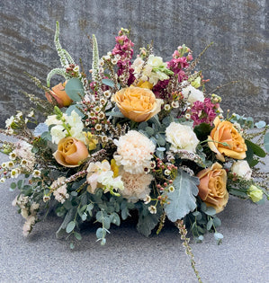 A floral arrangement using the Power of Three: 3 foliages, 3 line flowers, 3 mass flowers, and 3 filler flowers.