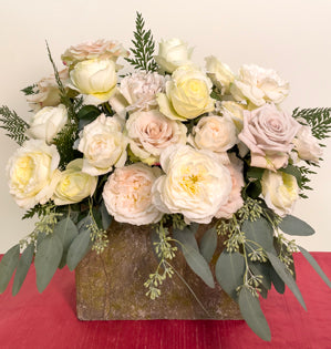 An abundant arrangement overflowing with a variety of white garden roses such as, Leonora, Quicksand, Patience, Purity, White Cloud, Menta, and Westminster Abbey, paired with seeded eucalyptus and Helecho fern.