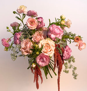 A beautiful blush wedding bouquet full of Sahara sensation roses, ranunculus, sweet william, butterfly ranunculus, hanging amaranthus, seeded eucalyptus and sage.