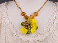 A hot trend in the floral world, flowers to wear pieces like this elegant floral necklace mix bling with beautiful materials like dancing lady orchids, berzillia berries, succulents, and other florets.