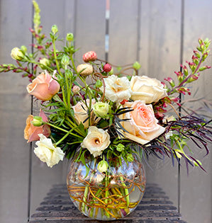 A gorgeous arrangement for the home combines curly willow, agonis, Golden Mustard roses, Princess Maya garden roses, foxglove, butterfly ranunculus and strawflowers.
