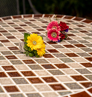 A modern wrist corsage is created using Israeli ruscus, miniature Gerbera daisies, and jewels for a bit of added bling.
