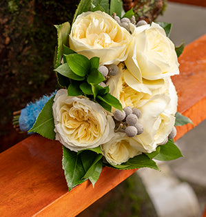 This prom flower bouquet features Leonora roses mixed with brunia, Israeli ruscus and fatsia leaves for a beautiful romantic effect.