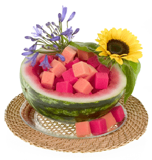 This vibrant fruit and floral centerpiece features blue agapanthus and a sunflower in a watermelon rind filled with bright foam cubes.