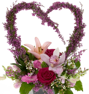 A romantic and beautiful Valentine's Day floral design uses a heart form made from heather and mixes a variety of flowers including lilies, orchids, Gerbera daisies, and red roses. 