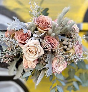 A gorgeous hand tied bouquet mixes eucalyptus, dusty miller, Westminster Abbey roses, Amnesia roses, Menta roses, kangaroo paw, brunia, and silver sage.