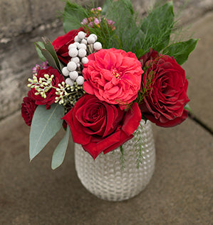 A versatile Valentine’s Day floral design (whether large or small) mixes Piano garden roses, Red Garnet spray roses, and two kinds of standard roses: Hearts and Freedom with brunia, waxflower, seeded eucalyptus, tree fern, and fatsia leaves.