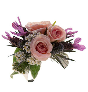 A gorgeous floral cuff in a blush, pink and blue color palette is created using lamb’s ear, yarrow, spray roses, butterfly lavender, and eryngium.