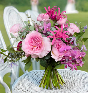A bouquet filled with lush garden roses, soft textures, and natural movement. 